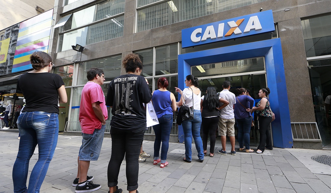 Fila de cidadãos na frente da agência da Caixa Econômica Federal