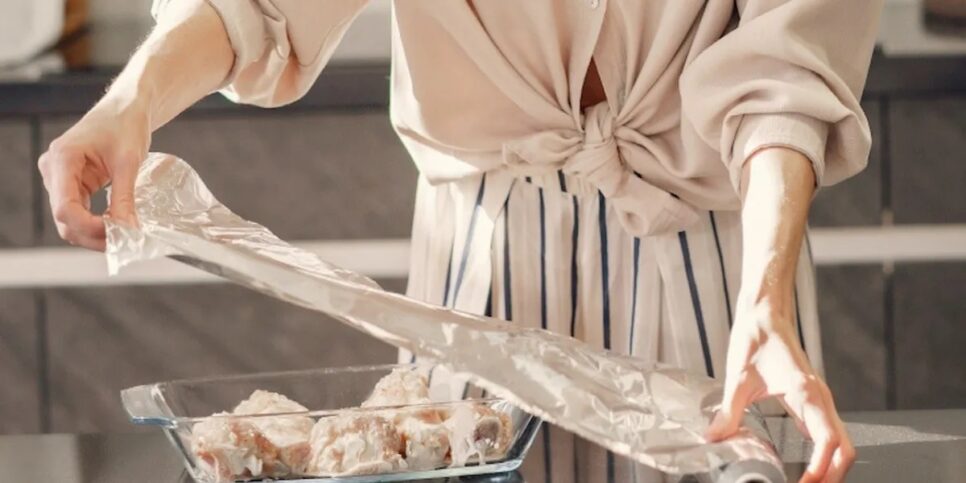 Dona de casa utilizando o papel alumínio para reservar seu alimento